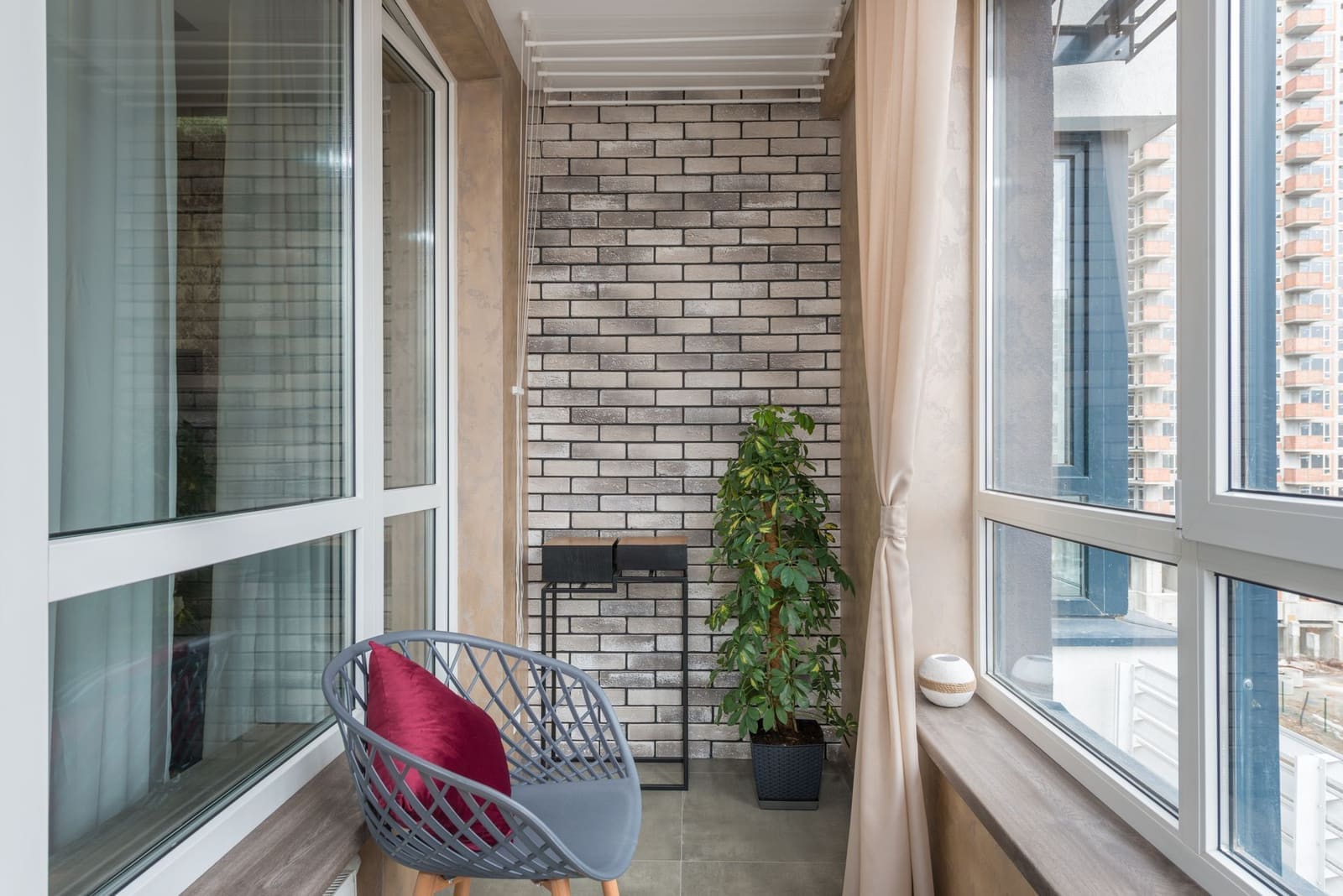 Penthouse lounge seating arranged around a west-facing window in Pune
